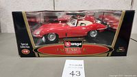 Front view of the Bburago 1:18 scale Jaguar E Cabriolet model in packaging