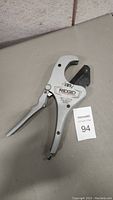 Full view of Ridgid ratchet pipe and tubing cutter showing the handle, blade, and logo.