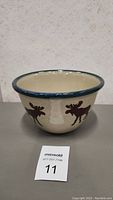 Full side view of the bowl highlighting the moose silhouettes and rim.