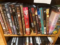 Photo of first shelf of DVDs with various action and martial arts movies including Casino Royale and The Gospel of John.