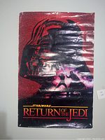 Star Wars Return of the Jedi poster showing Darth Vader silhouette and lightsaber and battle scene