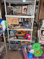 Shelf with vintage music books and sheet music visible, assorted toys, musical keyboard, and art supplies below on shelves