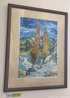 First detailed photo of the framed landscape art print featuring two tall trees with swirling brushstroke sky, showing the frame and matting.