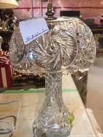 Full view of crystal table lamp showing detailed pinwheel etched glass lampshade and base with power cord included.
