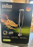 Front of box showing Braun Multi Quick 5V hand blender, 400W motor, variable speed control.