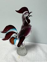 Full view of the Murano glass rooster figurine showing its profile and base on white background.