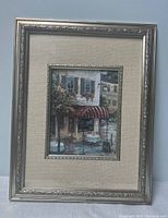 Full view of framed coffee house painting showing outdoor café tables and awning