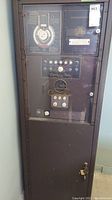 Front view of Schulmerich Auto Bell metal cabinet with control panel under glass.