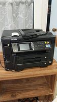 Front view of black Epson Workforce WF-3640 printer showing control panel with LCD screen, keypad, and function buttons.