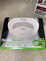Front-top view of iRobot Roomba Discovery vacuum box showing product image, brand, and model.