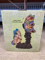 Original box showing image of the stained glass butterfly lamp with two butterflies and price tag of $79.99