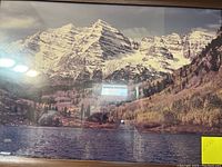 Photo of large framed landscape art featuring snowy mountains and water, showing 18x36 inch measurement on sticker