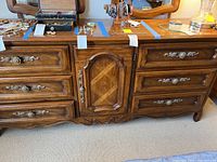 Full front view of the Drexel wooden dresser showing drawer fronts and central cabinet.