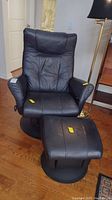 Front view of recliner and ottoman, showing overall condition and style