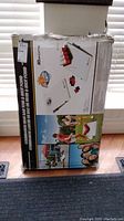 Original packaging box showing the bean bag toss and shot pong game set with color images of the assembled games and people playing outdoors.