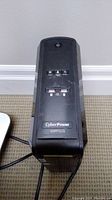 Front top panel of CyberPower UPS showing power button, buttons and display, model 1500PFCLCD.
