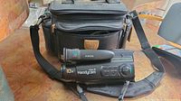 Sony Video 8 Handycam CCD-FX330 with carrying case and cables visible on the table.