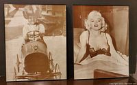 Two sepia-toned framed photos, one of Marilyn Monroe reclining, the other of a young child in a pedal car, both about 12" x 15" in black frames.
