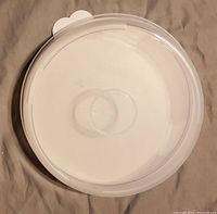 Top view of the Tupperware Pie Taker lid showing the sealing ring and white base underneath.