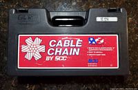 Front view of the black carrying case with handle showing red label 'Cable Chain by SCC' and model SC 1014 sticker.