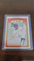 Front side of the 1972 Willie Mays baseball card in a protective plastic case depicting Mays in a Giants uniform with 'IN ACTION' banner.