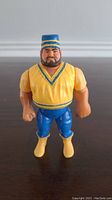 Front view of WWF Hasbro Akeem action figure showing facial features and clothing details