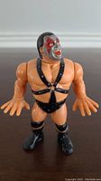 Front view of WWF Hasbro Demolition Ax action figure showing detailed face paint and wrestling outfit.