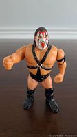 Front view of WWF Hasbro Demolition Smash action figure showing detailed face paint, harness, and boots.