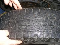Close-up photo of Blizzak tire tread showing detailed winter tread pattern and wear.