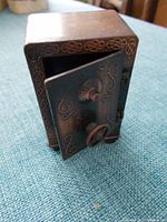 Brass floor safe pencil sharpener with detailed decorative door.