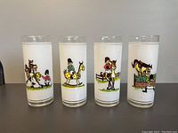All 4 frosted glasses shown displaying comedic horse race illustrations on a countertop