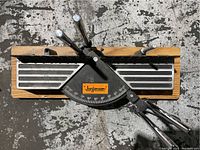 Top view of Jorgensen angle-finder mitre box showing wooden base and black steel protractor with degree markings and handles