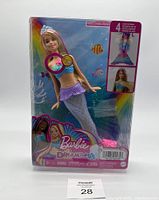 Front view of the Barbie Dreamtopia Twinkle Light Mermaid doll in box showing doll with light-up feature and colorful packaging.