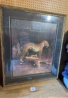 Full view of framed cheetah print showing frame and two cheetahs (one standing, one lying)
