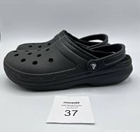 Side view of black Crocs classic clogs showing ventilated holes and heel strap
