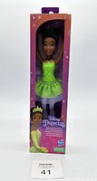 Front view of Disney Princess Tiana ballerina doll in packaging showing green ballet dress and tiara.