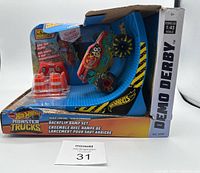 Photo of Hot Wheels Monster Trucks radio control backflip ramp set in packaging showing truck on blue ramp with remote and orange traffic cones.