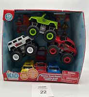 Photo of boxed Kid Connection Monster Truck Playset showing 6 vehicles and play accessories inside box.