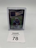 Front view of Nyheim Hines rookie card in plastic case showing patch and player image.