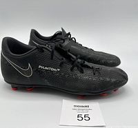 Side view of black Nike Phantom soccer cleats with red sole studs, size 9.