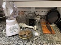 Full lot showing blender, jars, baking pans, glass platter, juicer, salt and pepper shakers, cheese board