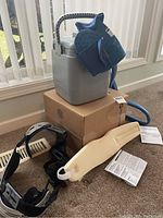 Overview of BREG Polar Care cold therapy unit with blue Intelli-Flo knee pad, knee brace, and accessories including foam padding and manuals.