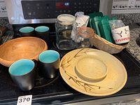 Photo showing chip and dip platter with bamboo design, wooden bowl, six mugs, jars with lids, green ice packs, and basket.