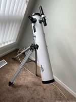 Full view of Orbitor 6500 altazimuth telescope mounted on metal tripod near window