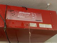 Front-side view of the red Craftsman Airborne Fine Dust Filter with label and power cord visible.