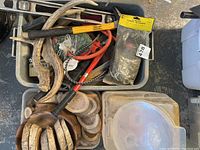 General overview of workshop tools in bins including bolt cutters, hammer, level, wood bowl with coasters, and antler pieces