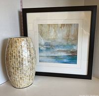 Photo showing both the framed abstract picture and ceramic shell vase side by side.