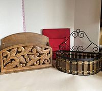 Group photo showing carved wooden file holder, red metal locker, and metal and wooden slat hanging shelf with decorative iron hanger.