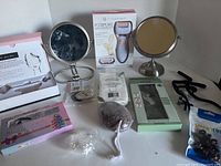 Full lot shown with included mirrors, pumice, Pedipure callus remover, Gua Sha sets, eyeglass stoppers, hair chalk color combs, and bra strap clips.