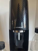 Close-up of SodaStream machine's top textured panel with SodaStream branding.